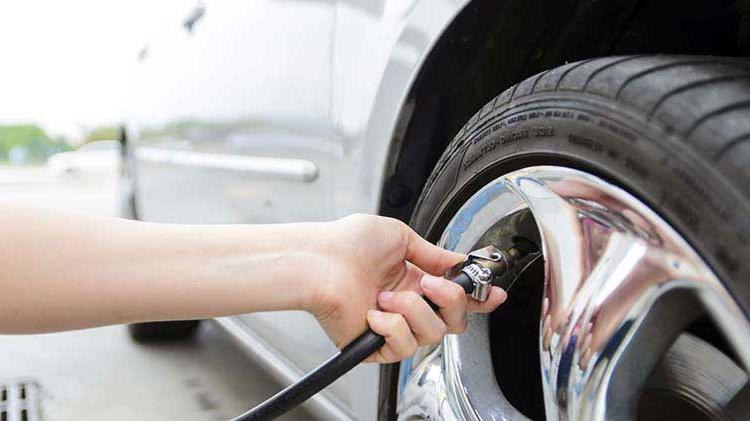 A person checking tire pressure.